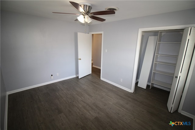 unfurnished bedroom featuring ceiling fan, dark hardwood / wood-style floors, and a closet