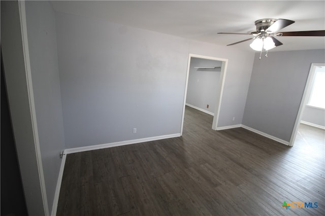 unfurnished room featuring ceiling fan and dark hardwood / wood-style flooring