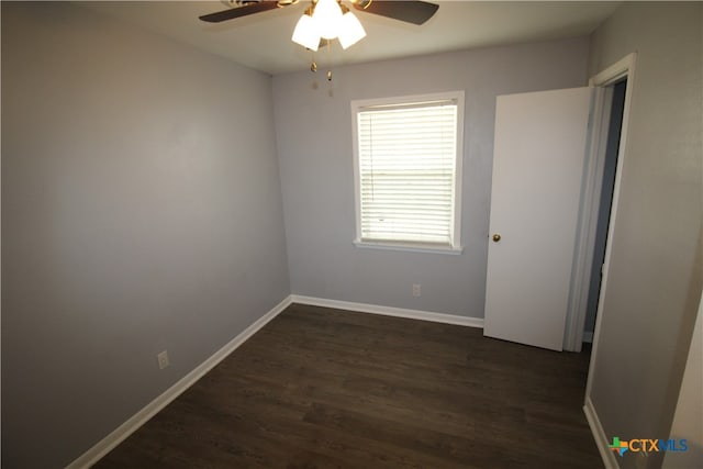 spare room featuring ceiling fan and dark hardwood / wood-style floors