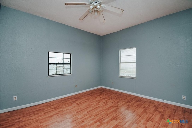 spare room featuring light hardwood / wood-style floors and ceiling fan