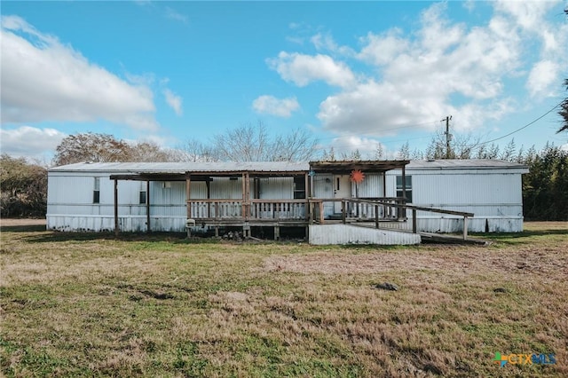 back of house with a lawn