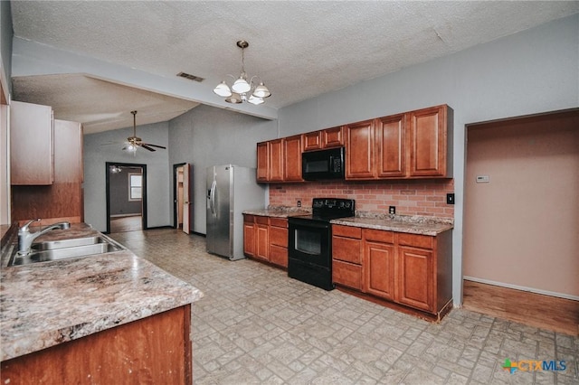 kitchen with sink, black appliances, pendant lighting, ceiling fan with notable chandelier, and backsplash