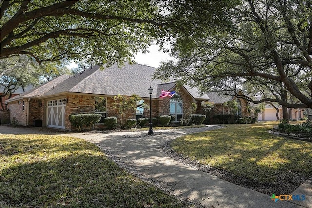 view of front of house featuring a garage and a front lawn