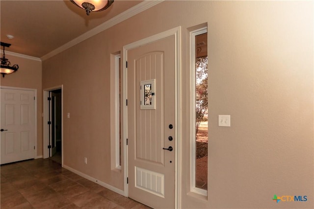 foyer entrance featuring crown molding