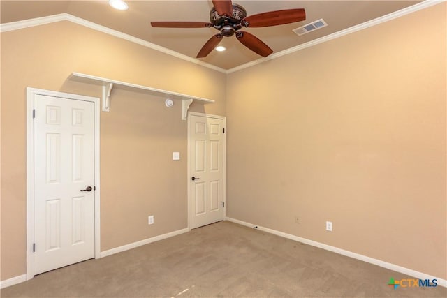 empty room featuring ceiling fan, lofted ceiling, ornamental molding, and carpet floors