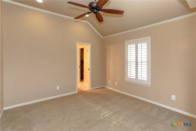 carpeted empty room with crown molding, lofted ceiling, and ceiling fan