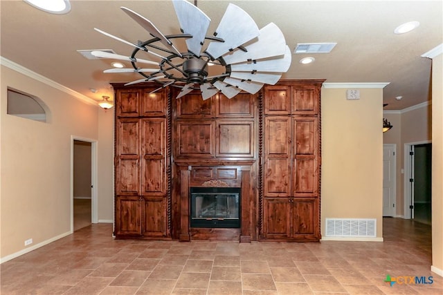 unfurnished living room with ornamental molding and ceiling fan