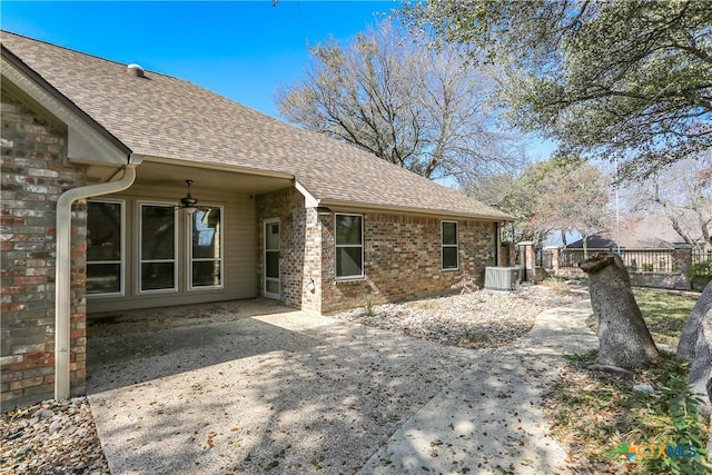 back of property with central AC unit, ceiling fan, and a patio area