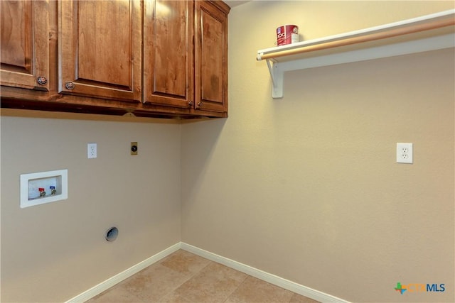 clothes washing area featuring cabinets, hookup for a washing machine, and electric dryer hookup