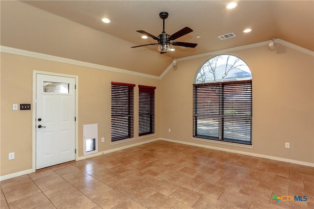 foyer featuring vaulted ceiling, ornamental molding, and ceiling fan