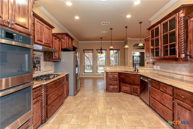 kitchen with appliances with stainless steel finishes, hanging light fixtures, tasteful backsplash, ornamental molding, and kitchen peninsula