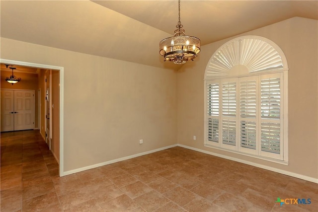 empty room with an inviting chandelier and vaulted ceiling