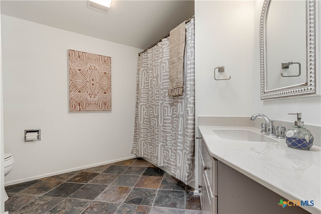 bathroom with vanity and toilet