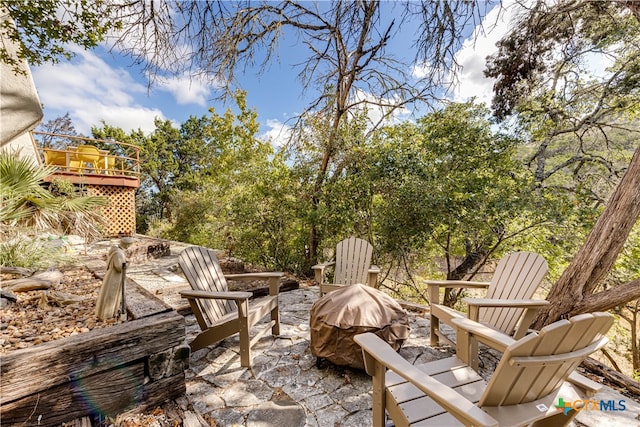 view of patio featuring an outdoor fire pit and a wooden deck