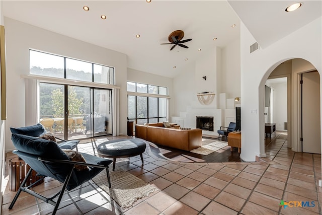 interior space featuring tile patterned floors, high vaulted ceiling, and ceiling fan