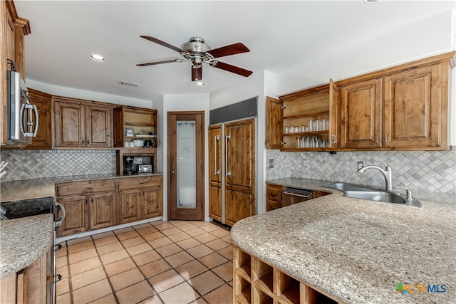 kitchen with backsplash, sink, and stainless steel appliances