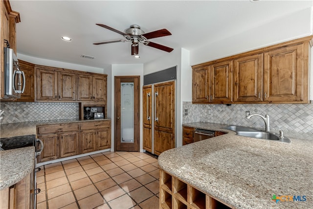 kitchen with decorative backsplash, sink, and appliances with stainless steel finishes