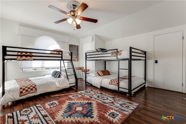 bedroom with dark hardwood / wood-style flooring and ceiling fan