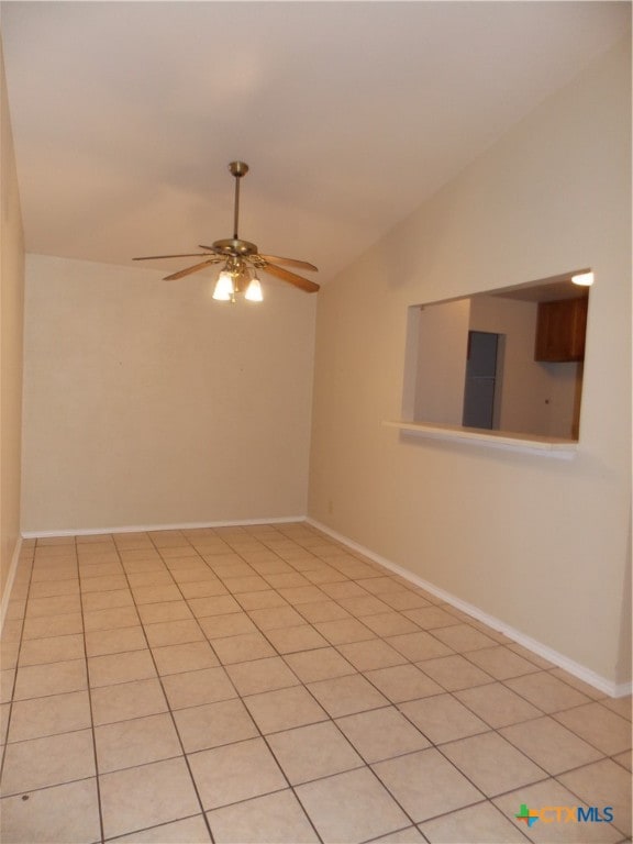 unfurnished room featuring lofted ceiling, light tile patterned floors, and ceiling fan