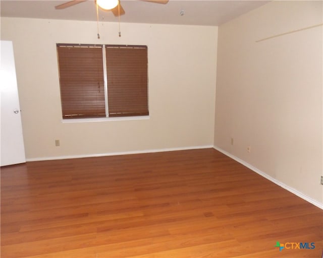 spare room with wood-type flooring and ceiling fan