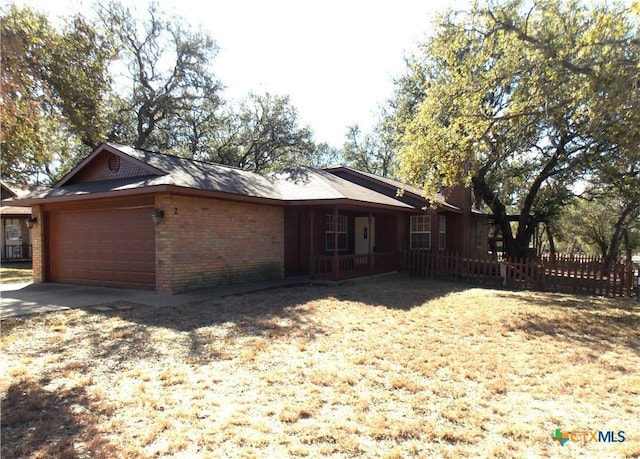 2 Rawhide Cir, Belton, TX 76513 - view of front facade featuring an attached garage, covered porch, brick siding, and concrete driveway