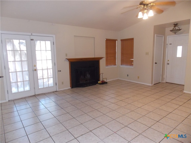 unfurnished living room featuring ceiling fan, french doors, vaulted ceiling, and light tile patterned flooring