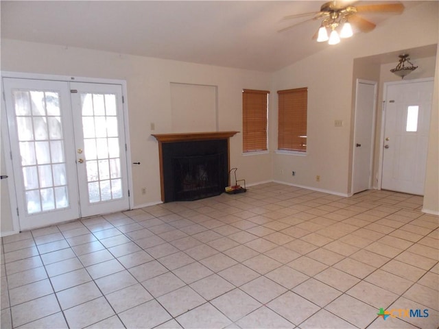 2 Rawhide Cir, Belton, TX 76513 - unfurnished living room featuring light tile patterned floors, ceiling fan, lofted ceiling, french doors, and a fireplace