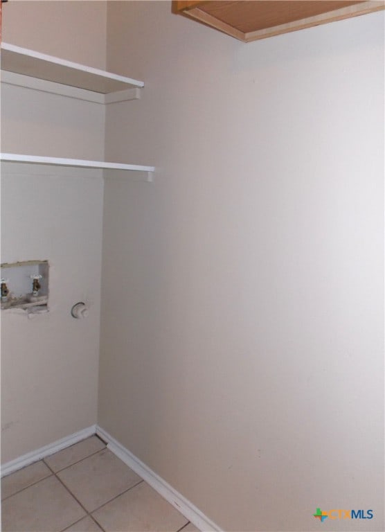 clothes washing area featuring washer hookup and tile patterned floors