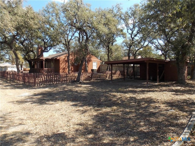 2 Rawhide Cir, Belton, TX 76513 - back of property featuring a carport and a chimney