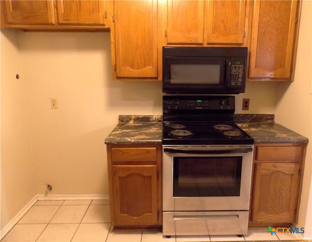 kitchen with light tile patterned floors and white stove