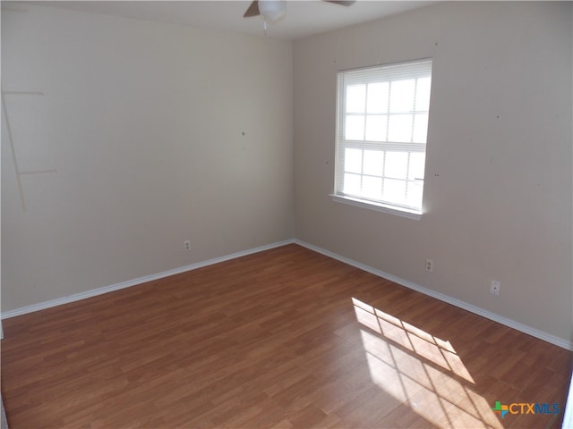 unfurnished room with hardwood / wood-style flooring and ceiling fan