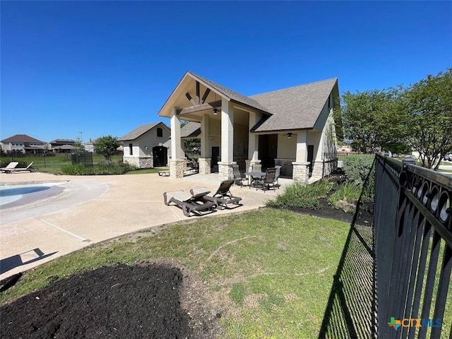 2092 Brandywine Dr, New Braunfels, TX 78130 - back of house with fence, a patio, stone siding, roof with shingles, and stucco siding