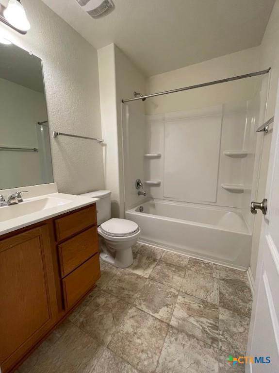 2092 Brandywine Dr, New Braunfels, TX 78130 - bathroom with vanity, toilet, shower / bathtub combination, and a textured wall