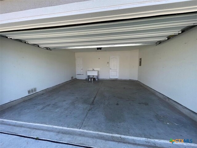 2092 Brandywine Dr, New Braunfels, TX 78130 - garage featuring a sink and a garage door opener