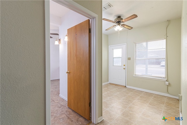 entrance foyer with ceiling fan