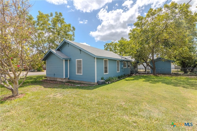 view of property exterior with central AC unit and a lawn