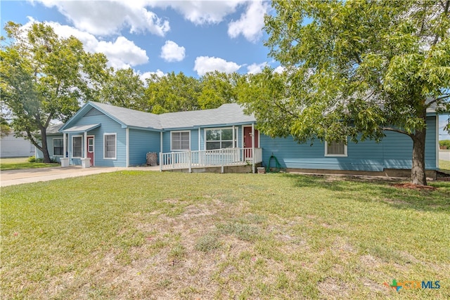 ranch-style home featuring a front lawn and covered porch