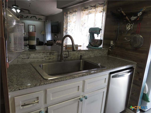 310 Rattan Dr, Victoria, TX 77901 - kitchen featuring backsplash, stainless steel dishwasher, white cabinetry, and light stone countertops