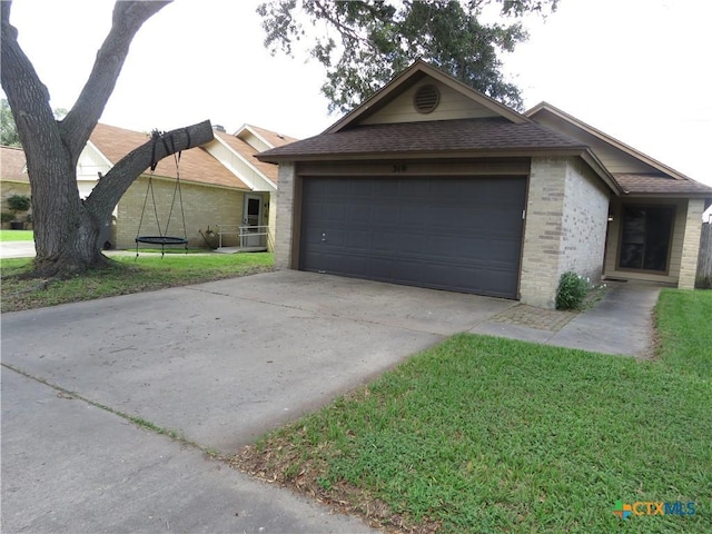 310 Rattan Dr, Victoria, TX 77901 - ranch-style home with brick siding, roof with shingles, a garage, concrete driveway, and a front lawn