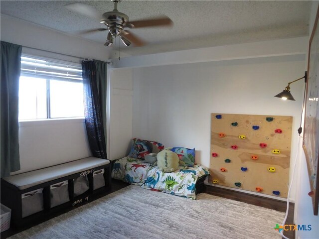 310 Rattan Dr, Victoria, TX 77901 - bedroom featuring a textured ceiling, a ceiling fan, and wood finished floors