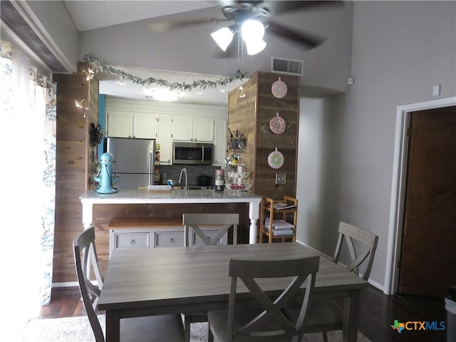 310 Rattan Dr, Victoria, TX 77901 - dining area with a ceiling fan, vaulted ceiling, and dark wood finished floors