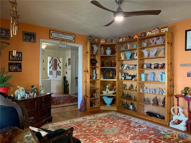 1101 S 17th St, Copperas Cove, TX 76522 - sitting room with wood finished floors, ceiling fan, and a textured ceiling