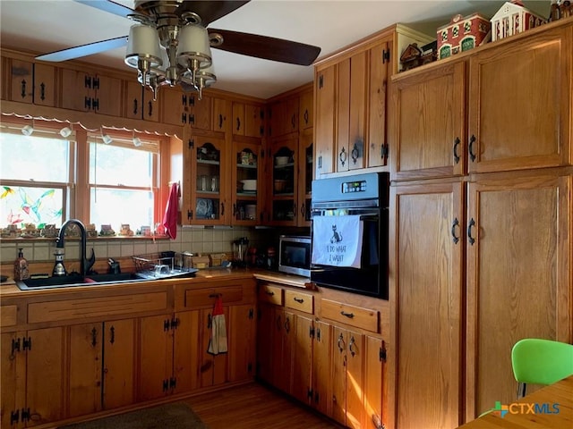 1101 S 17th St, Copperas Cove, TX 76522 - kitchen featuring oven, ceiling fan, stainless steel microwave, a sink, and brown cabinetry
