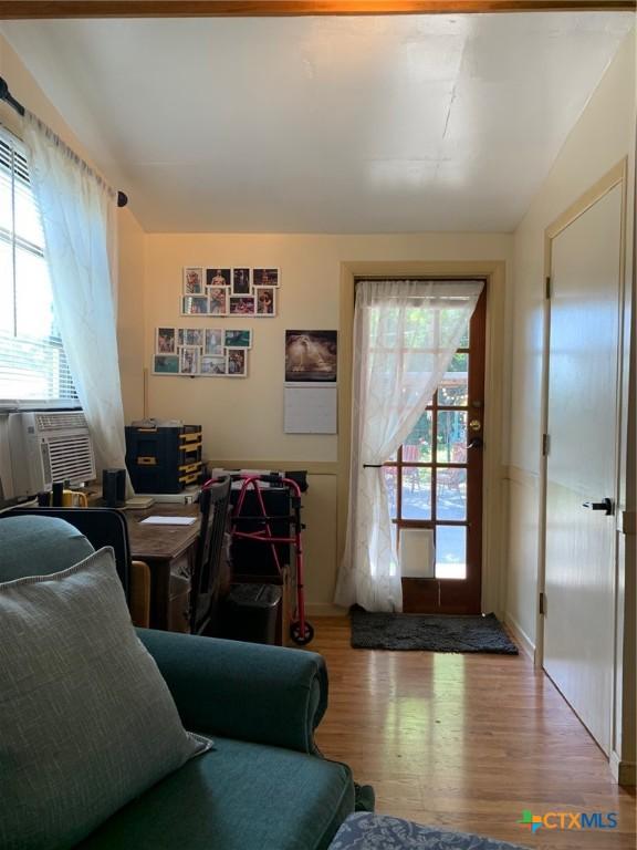 1101 S 17th St, Copperas Cove, TX 76522 - living area with wood finished floors, cooling unit, a desk, and vaulted ceiling