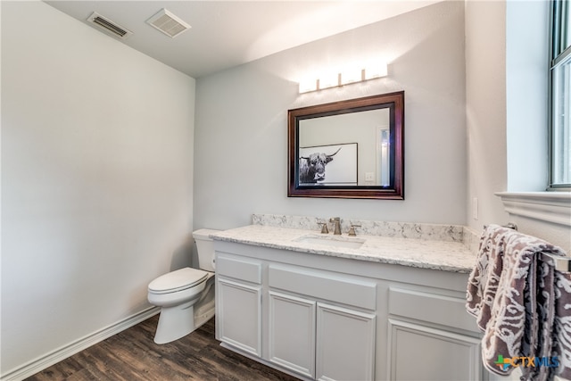 bathroom featuring hardwood / wood-style floors, vanity, and toilet