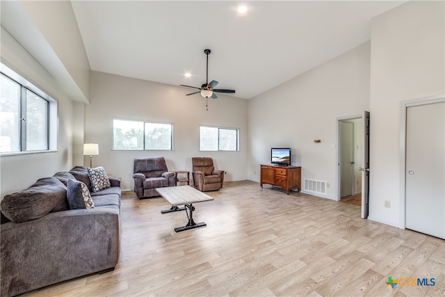 living room featuring high vaulted ceiling, light hardwood / wood-style flooring, and ceiling fan