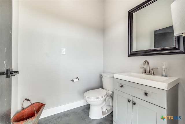 bathroom featuring vanity, toilet, and concrete floors