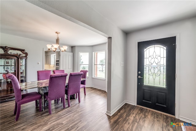 foyer entrance with a chandelier and dark hardwood / wood-style floors