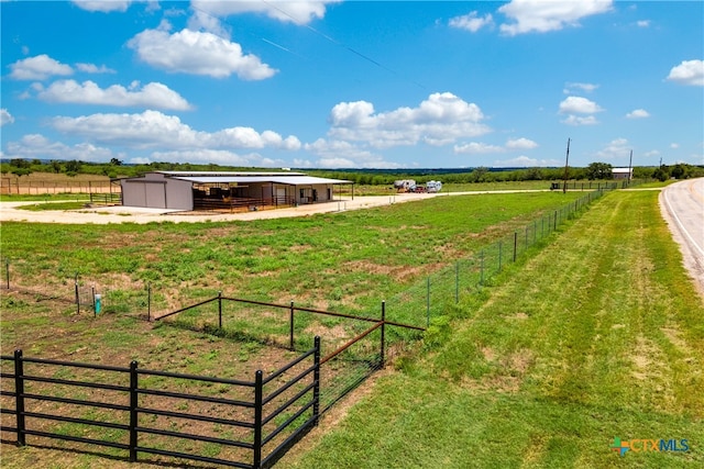 view of yard featuring an outbuilding and a rural view