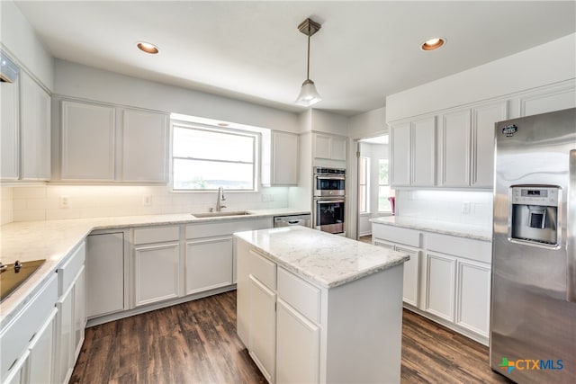 kitchen featuring pendant lighting, stainless steel appliances, white cabinets, and plenty of natural light